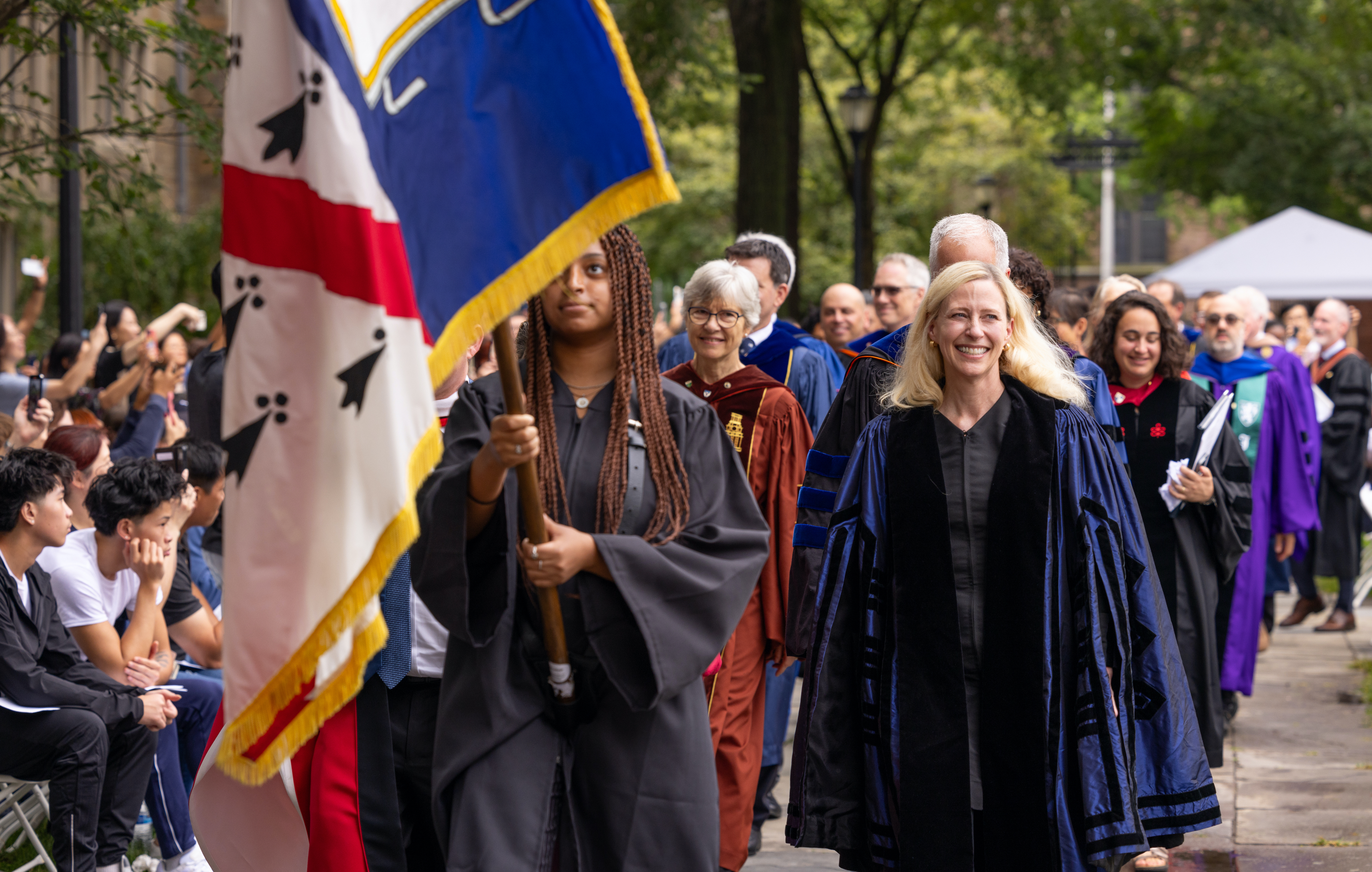 President McInnis smiling at the crowd as she walks in Yale's commencement procession.